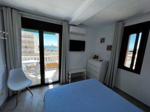 a bedroom with a bed and a window with a view at Apartamentos Roquetas Beach in Roquetas de Mar