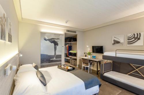 a hotel room with a bed and a desk and a bedroom at Nautilus Family Hotel in Pesaro
