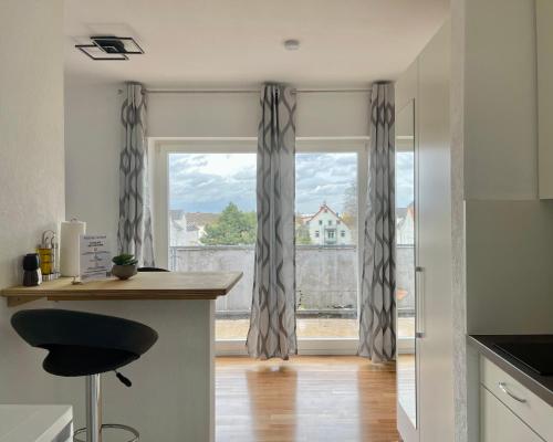 a kitchen with a window with curtains and a counter at Studios in Osnabrück - Iburger Str. I home2share in Osnabrück