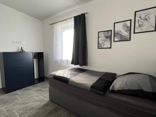 a bedroom with a bed and a window at Pension Hanisch in Buch