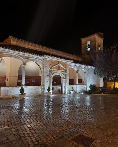 a large stone building with a courtyard at night at Hotel Rural Luna Llena in Torremocha de Jarama