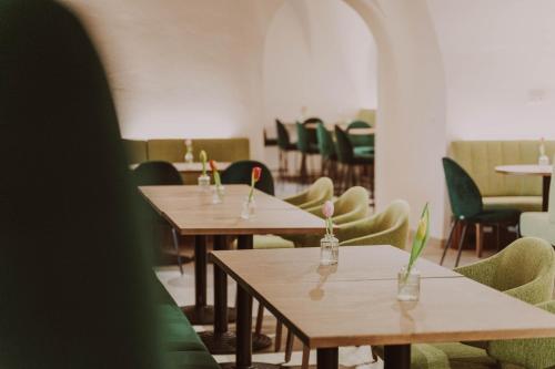a dining room with tables and chairs and chairs at Burghotel Schlaining in Stadtschlaining