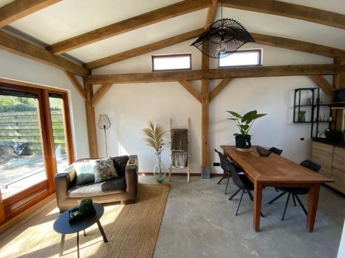 a living room with a table and a couch at Zantverde in Zandvoort