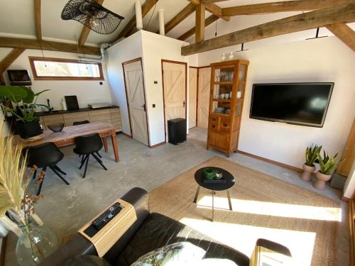 a living room with a couch and a table at Zantverde in Zandvoort