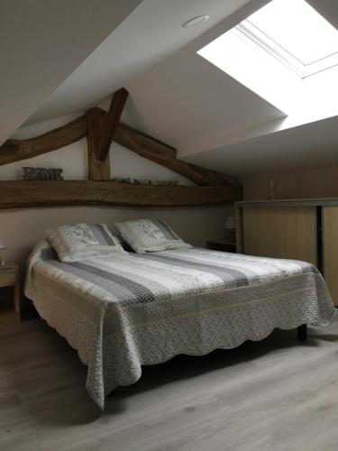a bedroom with a bed in a attic at Gîte de brizolles in Cluny