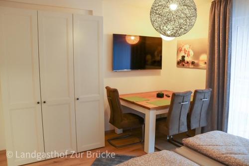 a dining room with a table and chairs at Aparthotel Layblick in Senhals