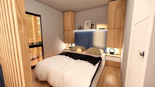 a bedroom with a bed and a window at Chalets & Glamping Nassfeld by ALPS RESORTS in Kötschach