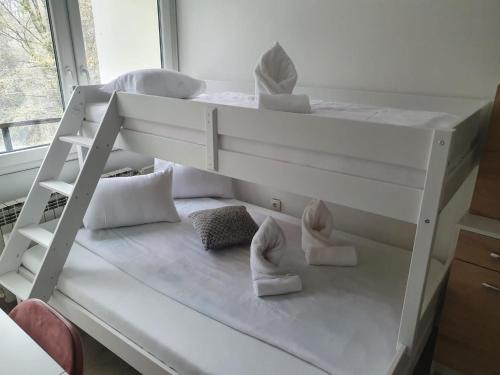 a white bunk bed with shoes on it in a room at Center of Plitvice + Free Parking + Self Check-in in Plitvička Jezera