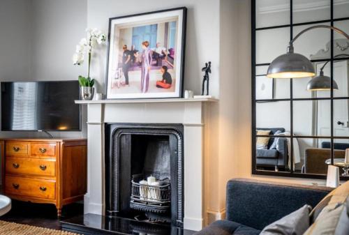 a living room with a fireplace with a picture above it at 42 is the Answer- Stunning York townhouse appearing on TV Holiday Home Show in York