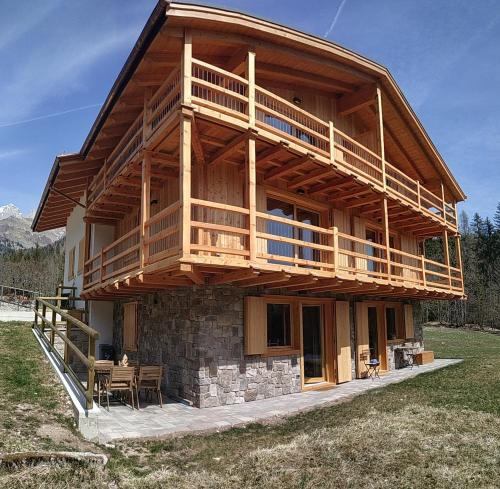 a large wooden house with a large balcony at Tabiá sui Prá - appartamento monolocale Anna in Falcade