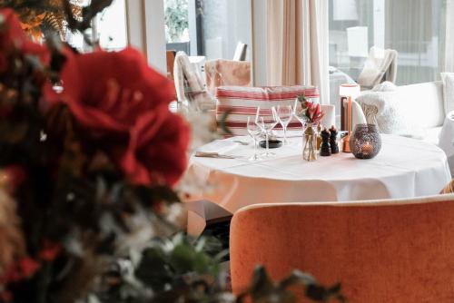 a table with a white table cloth and a vase on it at Lebeaubylivingroom Hotel in Knokke-Heist