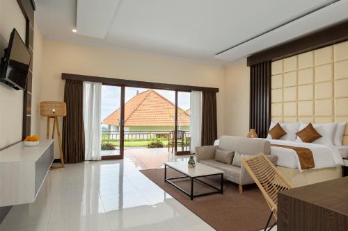 
a living room filled with furniture and a large window at Semabu Hills Hotel Nusa Penida in Nusa Penida
