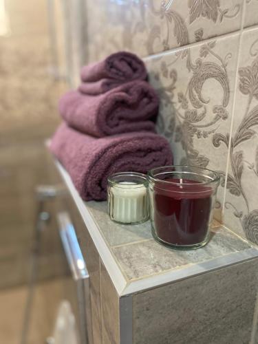 a towel and a candle on a shelf in a bathroom at NM Residence in Shkorpilovtsi