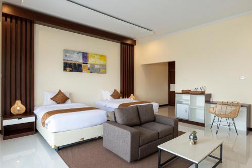 a hotel room with two beds and a chair at Semabu Hills Hotel Nusa Penida in Nusa Penida