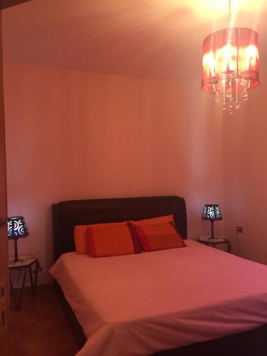 a bedroom with a bed and a chandelier at Charming House in Amman + Balcony in Amman