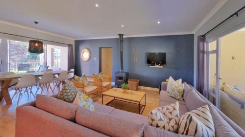 a living room with a couch and a dining room at Saints Rest in Clarens
