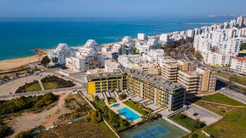an aerial view of a city and the ocean at Parque Atlântico Apartment T1 in Quarteira