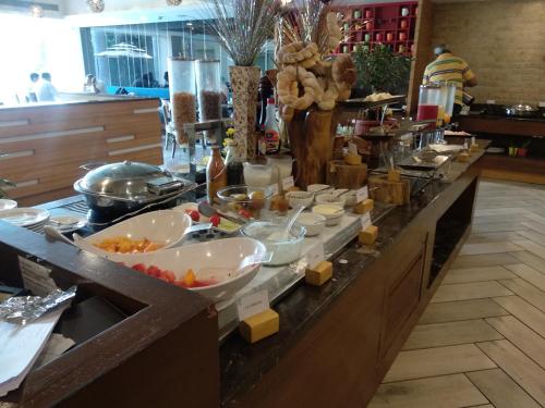 a buffet line with bowls of food on it at Country Inn & Suites By Radisson Jammu in Jammu