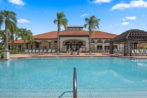 a large swimming pool in front of a building at Huge 6Br 6Bath Villa & Private pool Min to Disney in Kissimmee