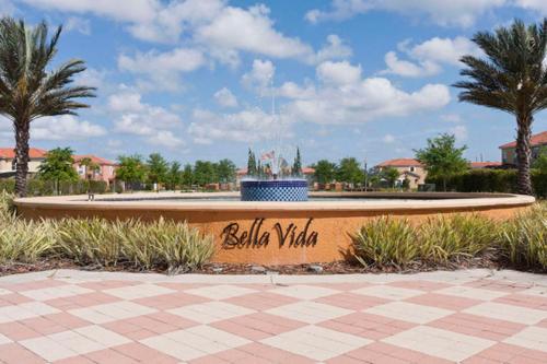a sign in front of a fountain in a park at Huge 6Br 6Bath Villa & Private pool Min to Disney in Kissimmee