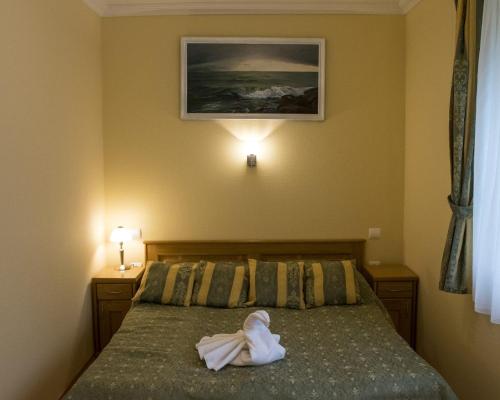 Posteľ alebo postele v izbe v ubytovaní Villa Apartman