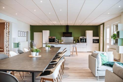 a kitchen and dining room with a large table and chairs at XXL Ferienhaus Goldberger See - Sauna - 16 Personen in Goldberg