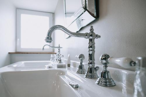 a bathroom sink with a silver faucet at Château de Labro - Teritoria in Onet le Château