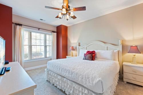 a bedroom with a white bed and a window at Tranquil 3BR Condo in Magnolia Pointe near Myrtlewood Golf Resort in Myrtle Beach