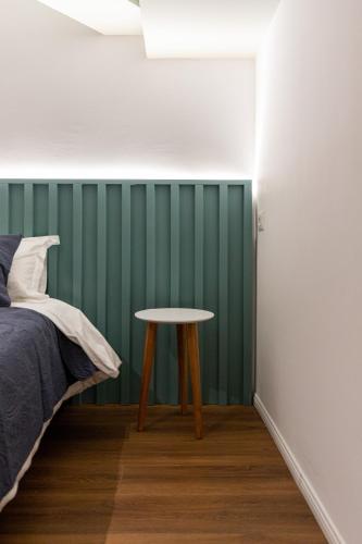 a bedroom with a table next to a bed at Spa & Pool - Studio Apartments 365 in Tirana