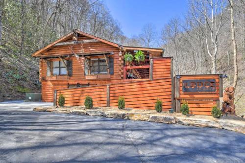 a log cabin in the woods with a driveway at The Lodge Nantahala River in Bryson City