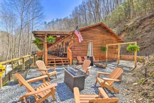 a log cabin with rocking chairs and an american flag at The Lodge Nantahala River in Bryson City