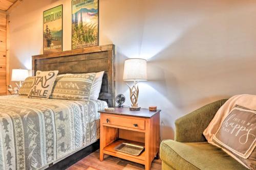 a bedroom with a bed and a chair and a table at The Lodge Nantahala River in Bryson City