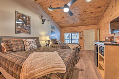 a bedroom with two beds in a log cabin at The Lodge Nantahala River in Bryson City