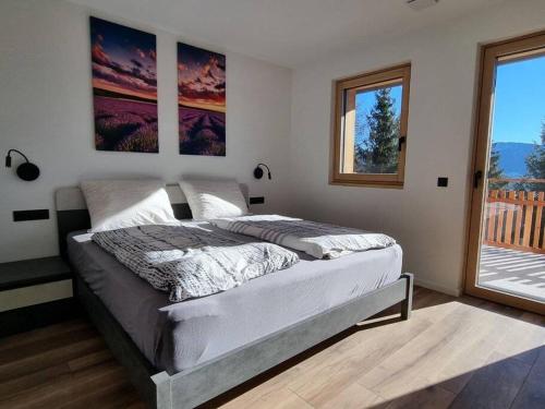 een slaapkamer met een bed in een kamer met een raam bij Alone in Chalet with view on Dolomites in Villandro