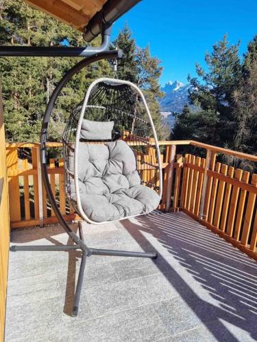 a swing on the porch of a house at Alone in Chalet with view on Dolomites in Villandro