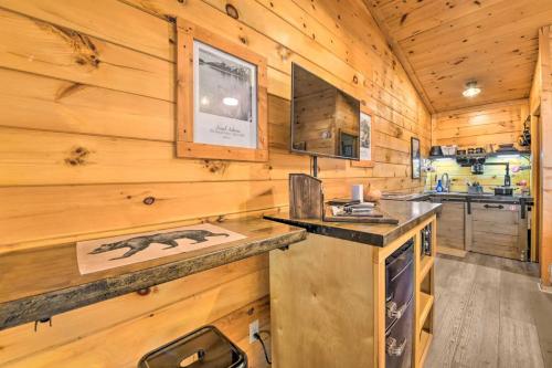 a log cabin kitchen with a counter and a stove at The Lodge Nantahala River in Bryson City