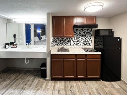 a small kitchen with a sink and a refrigerator at Studio 6 Suites Rockport, TX in Rockport