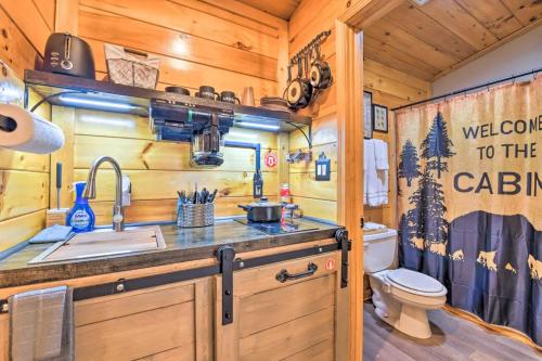 a bathroom with a toilet and a sink and a toilet istg at The Lodge Nantahala River in Bryson City
