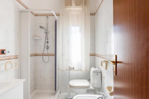 a bathroom with a toilet and a shower at Giardini Naxos Apartment with Terrace near the Sea in Giardini Naxos