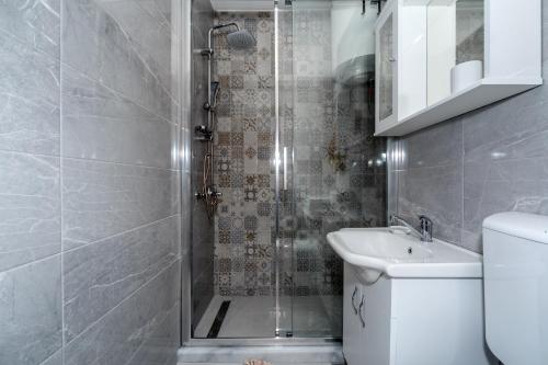 a bathroom with a shower and a toilet and a sink at barapartman_centar in Bar
