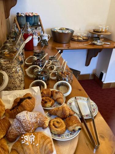 a table with various types of bread and pastries at Garni La Casetta in Livigno