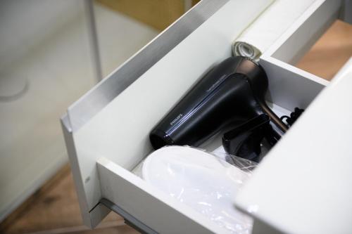 a black bottle of wine in a drawer at VILLA IN BED in Quarto