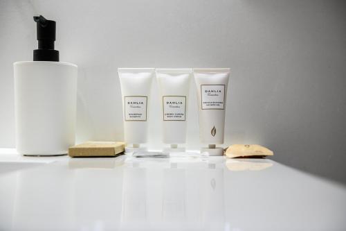 a group of three bottles of moisturizers and a bottle of soap at VILLA IN BED in Quarto