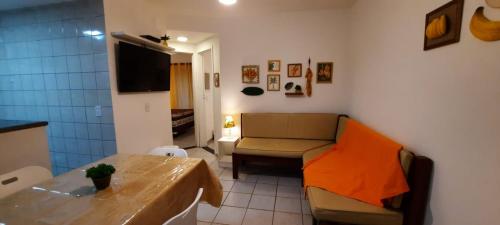 a small living room with a couch and a table at Ap 529 - Golden Village Taperapuã in Porto Seguro