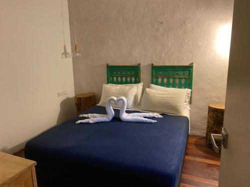 two swans laying on a bed in a bedroom at Lima.Tujoh in Kuching