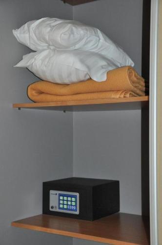 a shelf with a pillow and a clock on it at Liberty in Blankenberge