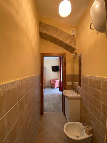 a bathroom with a sink and a toilet at La Torre della Piramide in Pitigliano