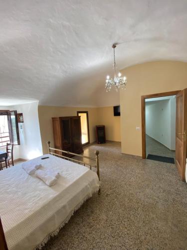 a bedroom with a bed and a chandelier at La Torre della Piramide in Pitigliano