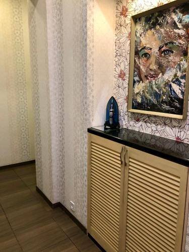 リヴィウにあるApartment Studio-біля Вокзалу-недалеко від Центру-Городоцька 151の電話付き壁面の女性絵画