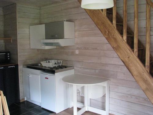 a kitchen with a stove and a stool in a room at Apartment Chalet Bourg d'Oisans in Le Bourg-dʼOisans